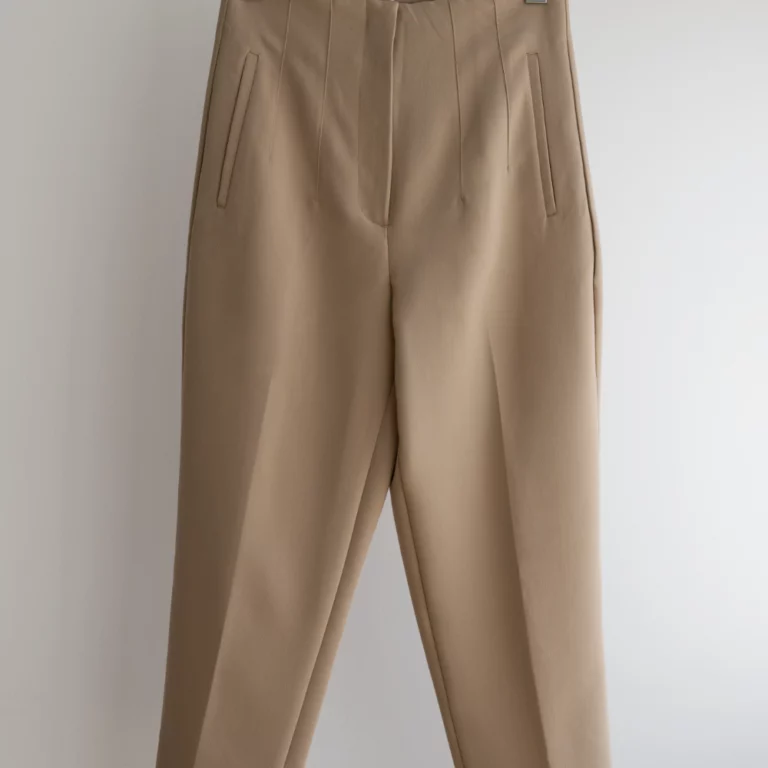 hand-holding-light-brown-beige-pants