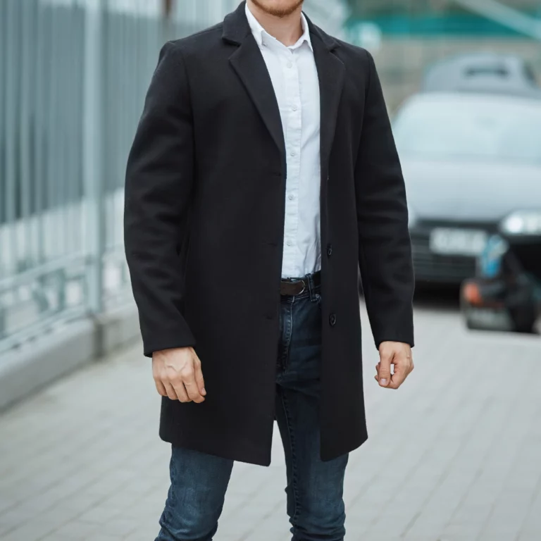 man-black-coat-with-white-shirt-standing-near-parked-car-city-street