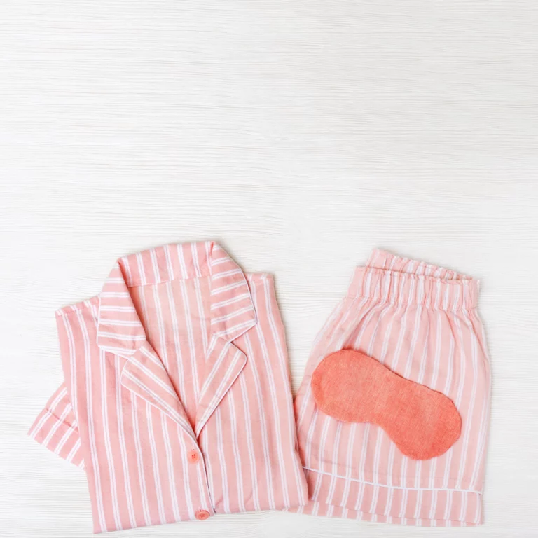 pink-pajamas-girls-eye-mask-sleeping-white-wood